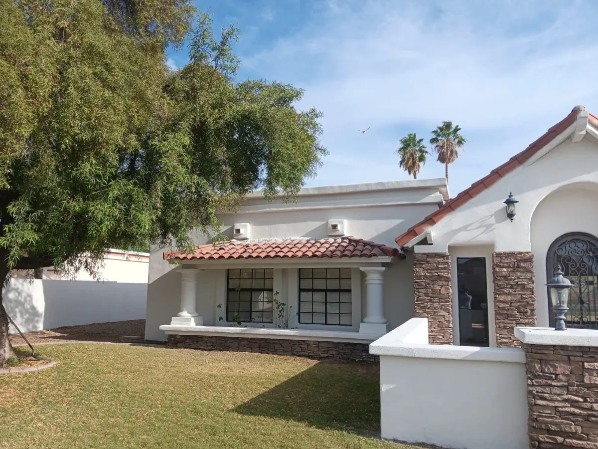 Finished Scottsdale home with a light exterior and stone-framed front entry